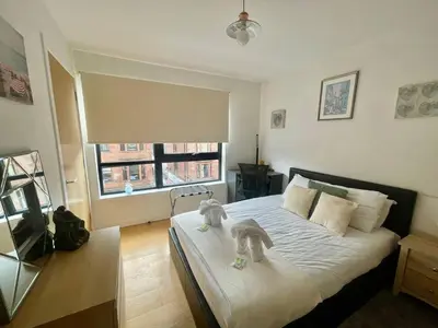 a bedroom with a bed with two dogs on it at Perfect Location in Heart of Glasgow West End - Pass the Keys in Glasgow