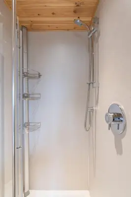 a shower in a bathroom with a wooden ceiling at Chalet Loch Leven Lodge 21 by Interhome in Kinross