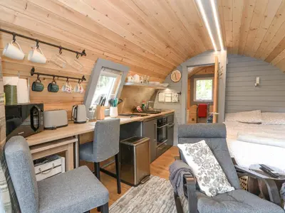 a kitchen and living room in a tiny house at Elleric Pods - The Last Resort in Appin