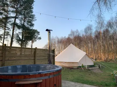 a tent and a tub in a yard at North Lodge Glamping in Carnwath
