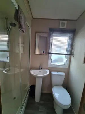a bathroom with a toilet and a sink and a shower at 5 lochview in Beattock