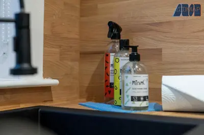 two bottles of alcohol sitting on top of a counter at Cosy 2-Bed House I Easy Edinburgh Access I Sleeps 4 in Whitburn