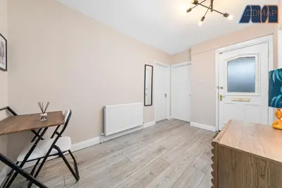 an empty living room with a table and chairs at Cosy 2-Bed House I Easy Edinburgh Access I Sleeps 4 in Whitburn