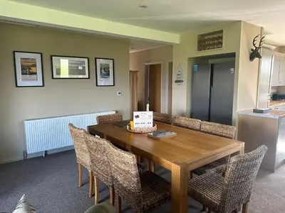 a dining room with a table with a cake on it at Ardenvhor - Loch Lomond in Gartocharn