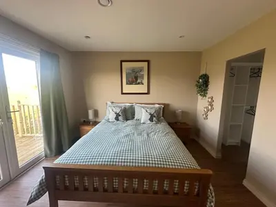 a bedroom with a bed and a window at Ardenvhor - Loch Lomond in Gartocharn