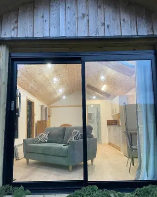 a living room with a couch in a house at Studio with a View in Onich
