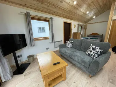 a living room with a couch and a tv at Studio with a View in Onich