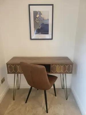a desk with a chair and a picture on the wall at Turnberry Rest-Coorie Doon Stays in Turnberry