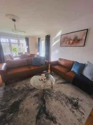 a living room with a couch and a table at Turnberry Rest-Coorie Doon Stays in Turnberry