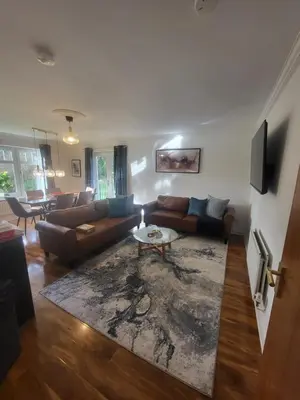 a living room with a couch and a table at Turnberry Rest-Coorie Doon Stays in Turnberry