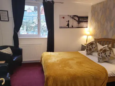 a hotel room with a bed and a window at Maridon House in Oban