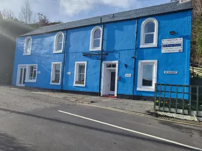 a blue building on the side of a street at Maridon House in Oban