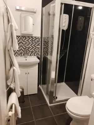a bathroom with a shower and a toilet and a sink at Maridon House in Oban