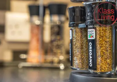two containers of seasoning sitting on top of a counter at Oxford Apartment by Klass Living in Coatbridge