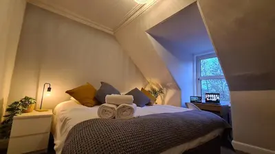 a bedroom with a bed with two towels on it at 5 Bedrooms Sleeps 10 Full Kitchen Parking in Ayr