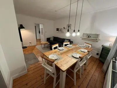 a dining room and living room with a table and chairs at Stirling Haven: Charming 3B Apt in City Centre in Stirling