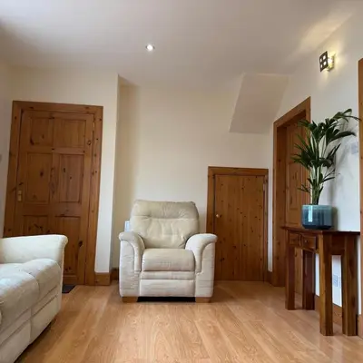 a living room with a chair and a couch at Mountain View House Kinlochleven in Kinlochleven