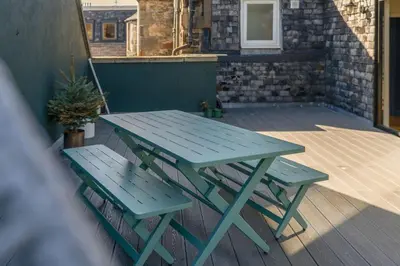 a picnic table and two chairs on a deck at GuestReady - Unique hideaway in Edinburgh in Edinburgh