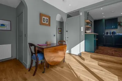 a room with a table and a chair and a kitchen at GuestReady - Unique hideaway in Edinburgh in Edinburgh