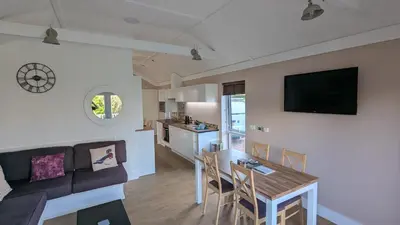 a living room with a couch and a table at The Dochart Lodge with hot tub Braidhaugh Crieff in Crieff