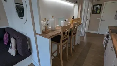 a small kitchen with a table in a tiny house at The Dochart Lodge with hot tub Braidhaugh Crieff in Crieff