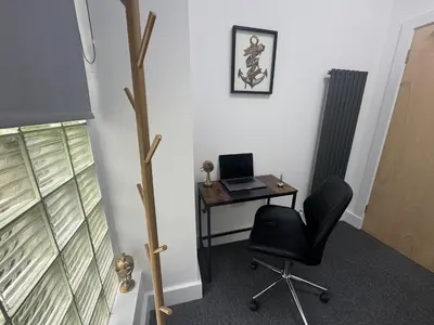 an office with a desk with a laptop and a chair at Squarezzz - Group Accommodation in Edinburgh
