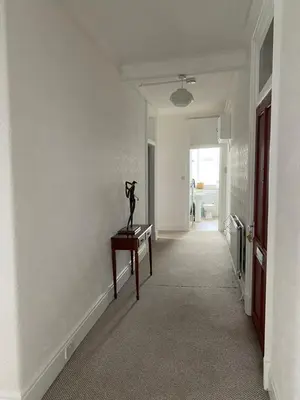 a hallway with a statue on a table in a room at Spacious 3 bedroom apartment in Campbeltown centre in Campbeltown