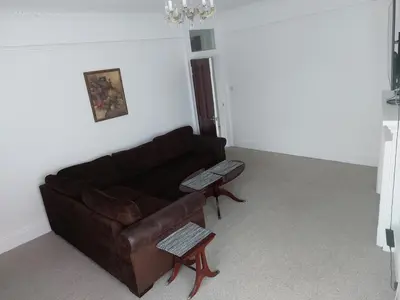 a living room with a couch and a table at Spacious 3 bedroom apartment in Campbeltown centre in Campbeltown
