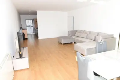 a living room with a couch and a tv at Glasgow Hydro Apt with Great Views in Glasgow