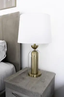 a lamp on a table next to a bed at Charlotte Apartment in Glasgow