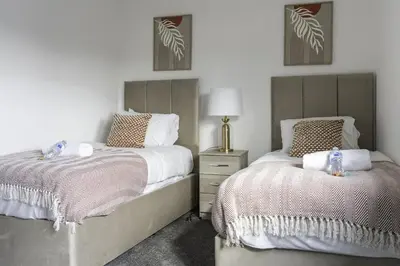 a bedroom with two beds next to each other at Charlotte Apartment in Glasgow
