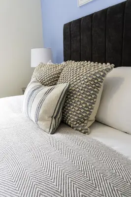 a bed with two pillows on top of it at Riverview House in Glasgow