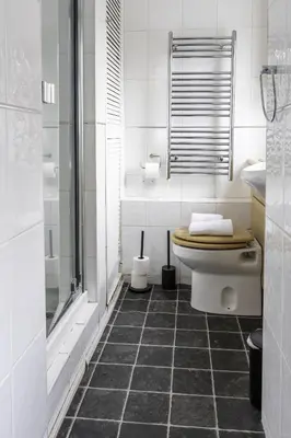 a white bathroom with a toilet and a shower at Riverview House in Glasgow