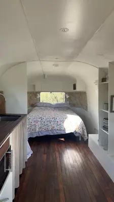 a bedroom with a bed in the middle of a room at Luxury Airstream Getaway with Sauna and Hot Tub in Gartness