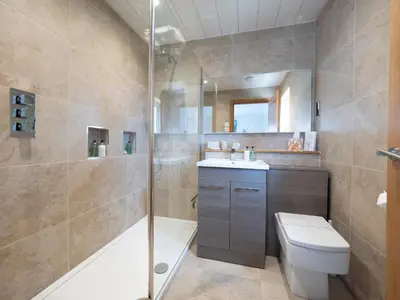 a bathroom with a shower and a toilet and a sink at East Laigh Gree Bed and Breakfast in Burnhouse