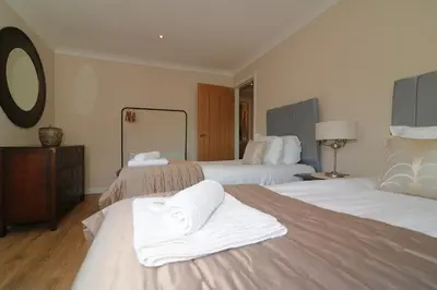 a hotel room with two beds with towels on them at Signature - Cross House in Lanark
