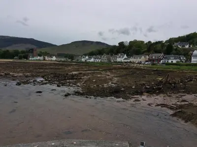 a view of the beach with houses in the background at Stonewater House Vegan Bed and Breakfast in Lamlash