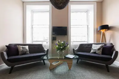 a living room with two couches and a coffee table at The Spires Serviced Apartments Edinburgh in Edinburgh