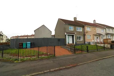 a fence in front of a house with houses at Signature - Drumvale House in Chryston