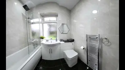 a white bathroom with a sink and a toilet at Home to Home in Glasgow
