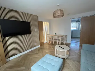 a living room with a couch and a table at 2 Bed on the Glasgow Green in Glasgow