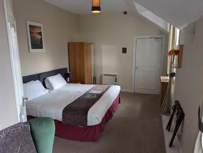 a hotel room with a bed in a room at Gordon Arms Hotel in West Linton
