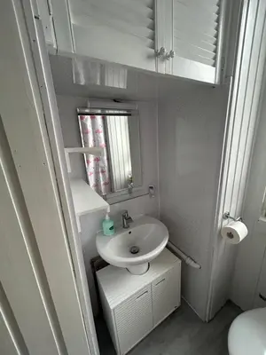 a small bathroom with a sink and a mirror at Bright bedroom with king side bed and share bathroom in Edinburgh