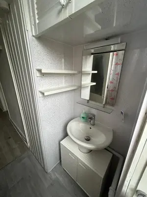 a small bathroom with a sink and a mirror at Bright bedroom with king side bed and share bathroom in Edinburgh