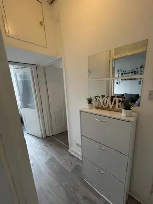 a room with a dresser and a mirror and a door at Bright bedroom with king side bed and share bathroom in Edinburgh