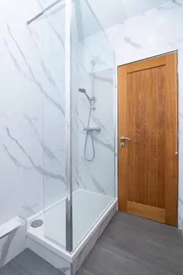 a shower with a glass door in a bathroom at Vacant Nests The Milton Dunfermline Parking in Dunfermline