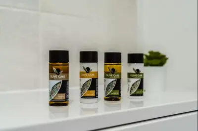 a group of four bottles of oil on a shelf at Cheerful 1 Bedroom Homely Apartment, Sleeps 4 Guest Comfy, 1 x Double Bed, 1 x Sofa Bed, Parking, Free WiFi, Suitable For Business, Leisure Guest,Glasgow, Glasgow West End, Near City Centre, Perfect for Common Wealth Games 2026 in Glasgow