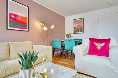 a living room with two couches and a table at 2BR Flat with Free Parking in Central Location in Glasgow