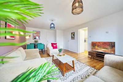 a living room with a couch and a tv at 2BR Flat with Free Parking in Central Location in Glasgow
