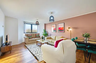 a living room with a couch and a table at 2BR Flat with Free Parking in Central Location in Glasgow